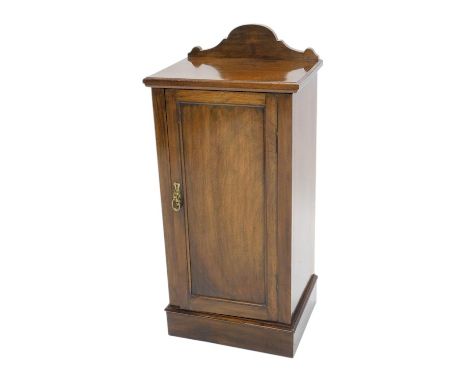 A 19thC walnut pot cupboard, with a raised back, above panelled door, on a plinth, 41cm wide.