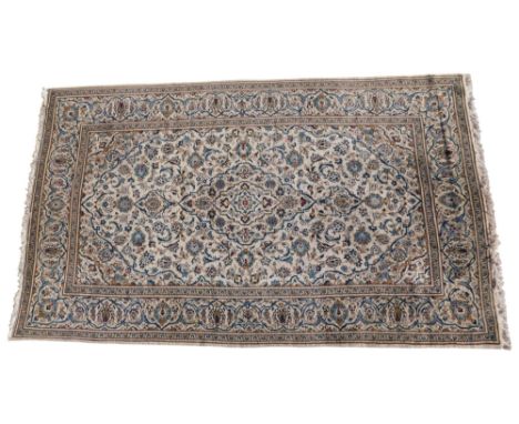 A Persian rug, with a design of scrolls, flowers, etc., on a beige ground, with multiple borders, 319cm x 198cm.