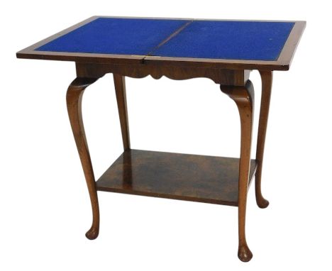 A figured walnut two tier card table, the rectangular fold over top with a cross banded border, on cabriole legs with pad fee