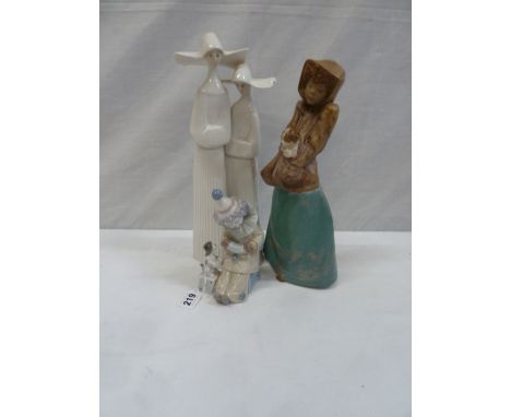 Lladro nun, Clown with squeeze box, and a Nao figure of girl holding puppy (3) 