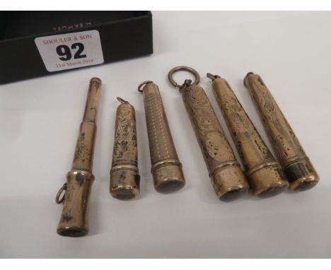 Early 20thC engraved and engine turned cigarette holders in cases (6)