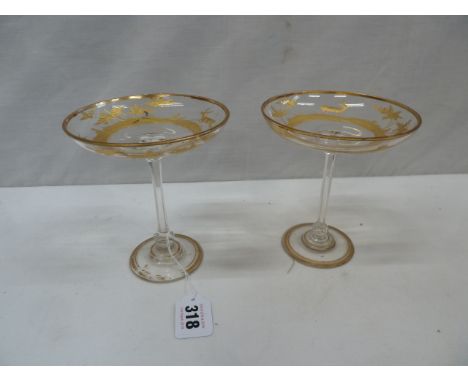Pair gilded cut glass shallow champagne glasses adorned with stag-hunting scenes