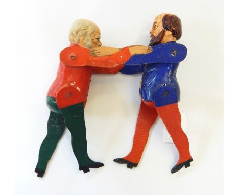 A Victorian political puppet of Gladstone & Disraeli facing one another, painted in bright colours  