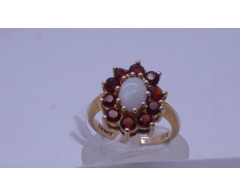 9 carat GOLD Opal dress ring, oval opal surrounded by Garnets size K, 3.5 grams 