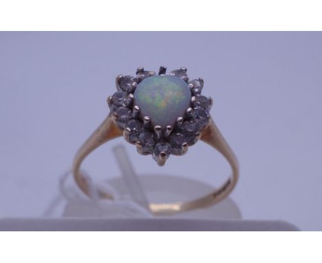 Ladies 9ct GOLD ring size N, a small opal to the centre surrounded CZ stones, one stone missing 2.1 grams 