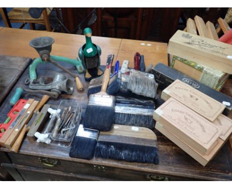 A COLLECTION OF DECORATING BRUSHES with assorted tools, two mincers and a group of wooden boxes