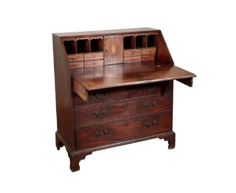 A GEORGE III MAHOGANY BUREAU the hinged lid containing a fitted interior, decorated with marquetry to the compartments, above
