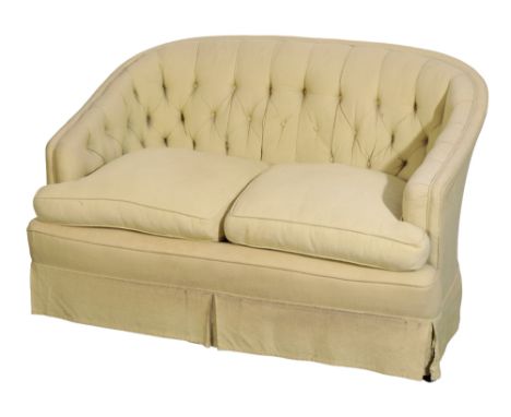 A BUTTONED SOFA with light green fabric covers, 79cm high x 126cm wide x 86cm deep. From The Estate of John Whitwell MS, FRCS