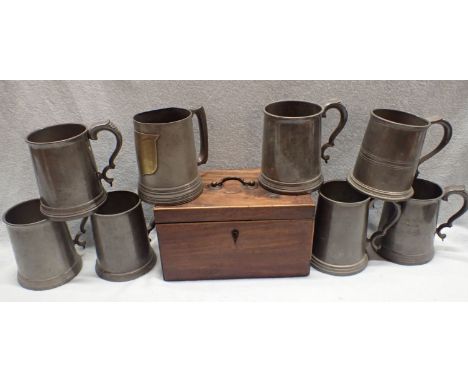 A 19TH CENTURY PEWTER MUG WITH BRASS SHIELD and glass bottom, seven other pewter mugs, and a mahogany tea caddy