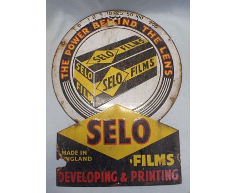 A 'SELO FILMS'  PHOTOGRAPHY ENAMEL ADVERTISING SIGN in the form of a lens; 'THE POWER BEHIND THE LENS' 43 x 58cm (one fixing 