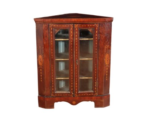 A GEORGE III MAHOGANY AND MARQUETRY CORNER CABINET in the neo-classical style, the glazed doors decorated with trailing bell 