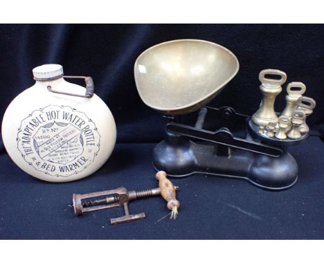 A VINTAGE STEEL MECHANICAL CORKSCREW WITH WOODEN HANDLE a Fulham Pottery hot water bottle, and a set of kitchen scales, with 