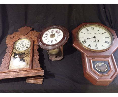 AN AMERICAN MAHOGANY CASED WALL CLOCK, the dial with "W. Wells &amp; Son, Stroud"; two other wall clocks and an enamel sign "