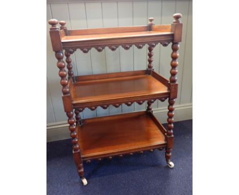 A VICTORIAN MAHOGANY BUFFET OR TROLLEY of small proportions, on bobbin turned supports and ceramic casters 61cm wide