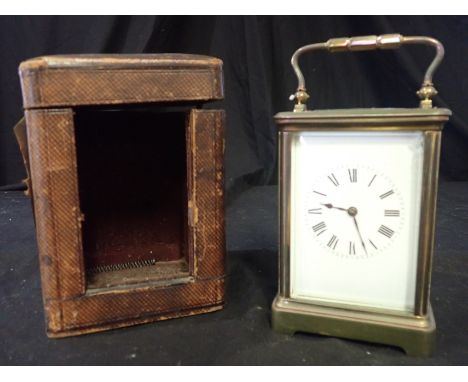 A FRENCH BRASS CASED STRIKING CARRIAGE CLOCK the movement striking on a coiled gong, 13cm high, in a fitted leatherette trave