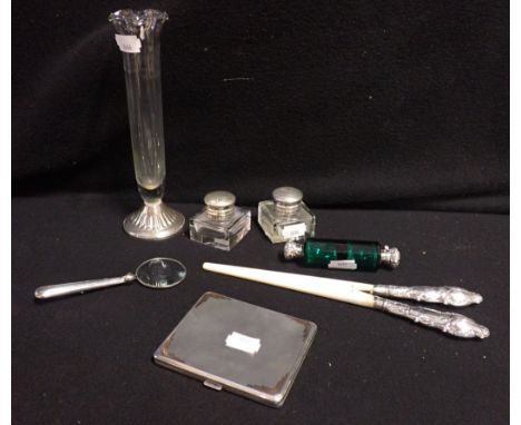 A SILVER CIGARETTE CASE with a silver magnifying glass, glove stretchers , silver topped inkpots and other similar 