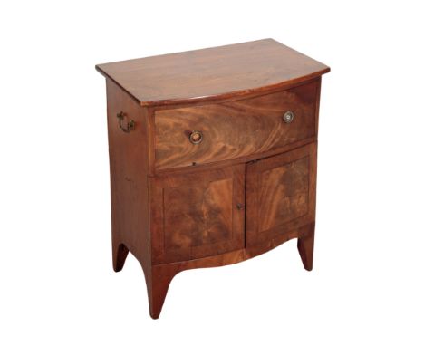 A GEORGE III MAHOGANY BEDSIDE COMMODE a single drawer to the frieze above two doors, carrying handles to either panelled side