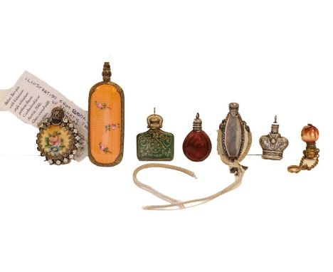 A collection of seven miniature scent-bottles, including two enamel examples, a silver example formed as a crown, probably fi