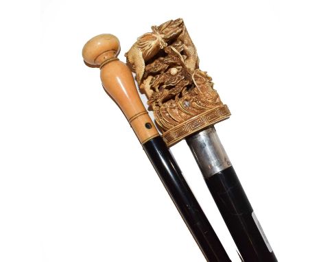 A late 19th/early 20th century ebony shafted and ivory handled walking cane, intricately carved with cloud bands, a dragon, f