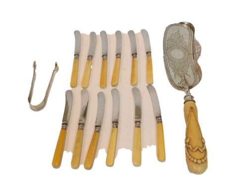 A collection of silver and ivory flatware and a pair of sugar tongs, comprising: a Victorian silver and carved ivory crumb sc