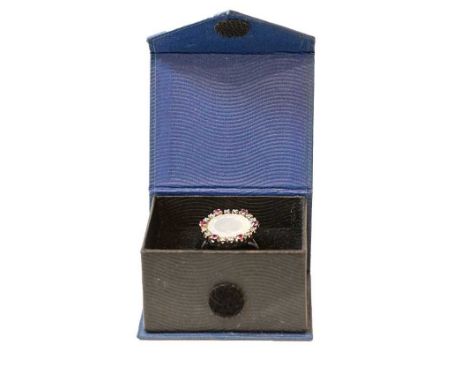 A synthetic ruby, white stone and mother-of-pearl ring, finger size O (a.f.)Condition report: Would have originally had a cul