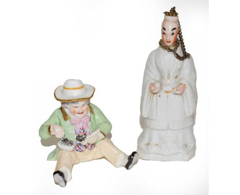 Two ceramic scent-bottles, one formed as a sitting man filling his pipe, his hat detachable as the stopper, the second formed