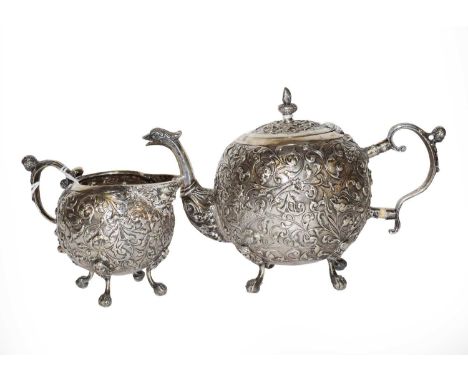 A Dutch silver teapot and cream jug, maker's mark possibly L6S, date letter lacking, circa 1900, each piece globular, chased 