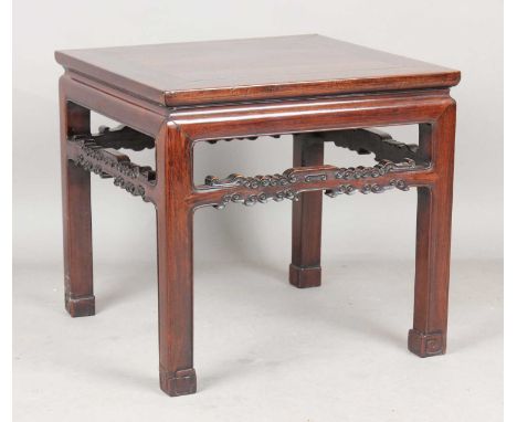 A Chinese hardwood table, late Qing dynasty, the square top above cloud scroll stretchers, on block legs, height 52cm, width 