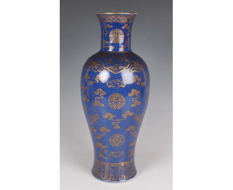 A Chinese gilt decorated powder blue glazed porcelain vase, Kangxi style but later Qing dynasty, the slender baluster body an