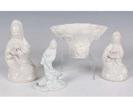 A Chinese blanc-de-Chine porcelain libation cup, probably Kangxi period, of traditional horn form, moulded in relief with a d