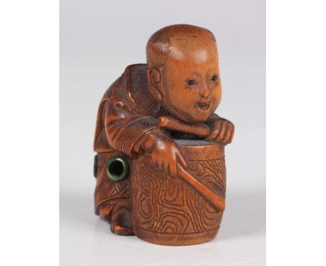 A Japanese carved boxwood netsuke, Meiji period, finely carved as a young boy playing a drum, incised signature to base, heig