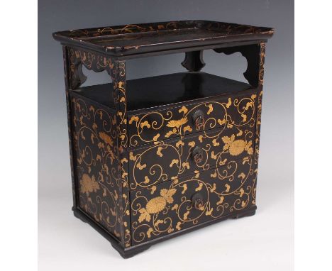 A Japanese lacquer table-top cabinet, Meiji period, the tray-top above an open shelf and three graduated long drawers, all gi