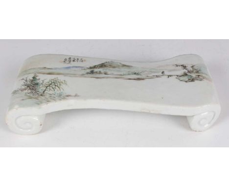 A Chinese Qianjiangcai enamelled porcelain brush rest, Republic period, of scroll form, the top painted with a riverside land
