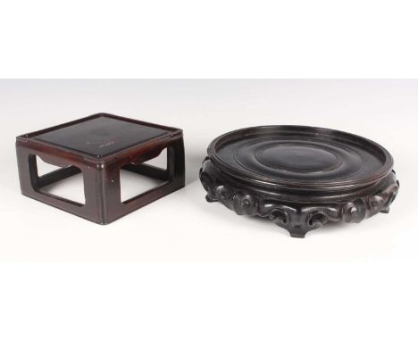 A Chinese carved hardwood circular stand, early 20th century, with carved and pierced ruyi-head and scroll apron, diameter 26