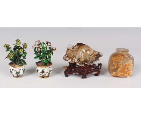 An agate Suzhou style agate snuff bottle, 20th century, of rounded form, one side carved with a seated sage, height 5.7cm (la