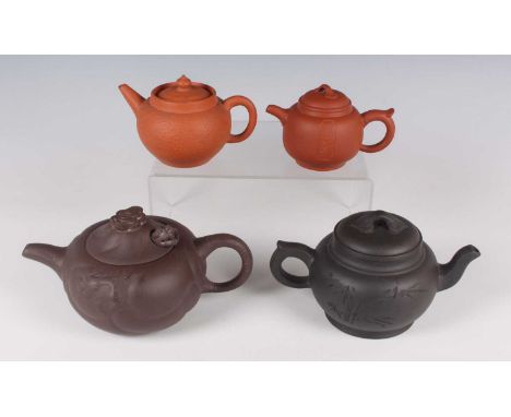A Chinese Yixing stoneware teapot and cover, 20th century, of diminutive globular form, one side incised with a three-charact