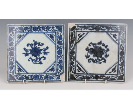 Two Chinese blue and white export porcelain square tiles, Kangxi period, each painted with lotus within scrolling tendril bor