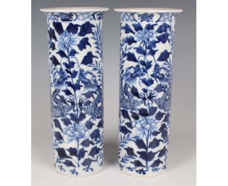 A pair of Chinese blue and white porcelain cylinder vases, mark of Kangxi but late 19th century, each painted with opposing d
