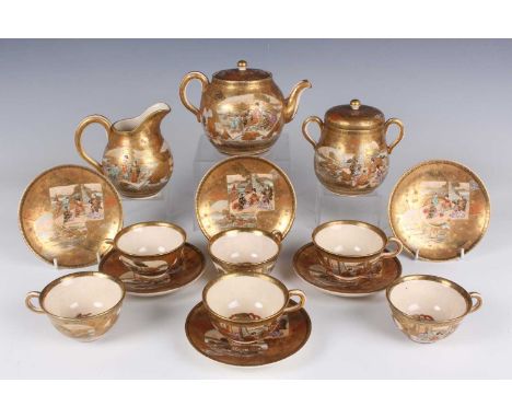 A Japanese Satsuma earthenware part tea set, Meiji period, each piece painted and gilt with panels of figures and landscapes 