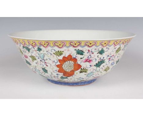 A Chinese famille rose enamelled porcelain circular bowl, mark of Qianlong but modern, the exterior painted with flowers and 