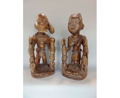 Two carved Benin type carved wooden tribal figures 