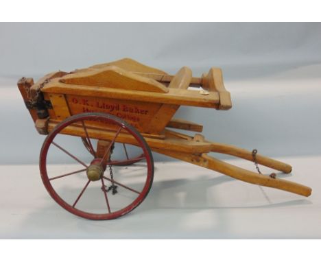 An Edwardian estate made toy tipping cart in elm with wire wheels, O K Lloyd-Baker, Hardwicke Cottages, Gloucestershire, 60 c