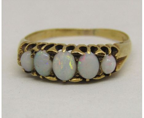 Graduated five stone opal ring in high carat gold, marks worn, size N, 2.7g