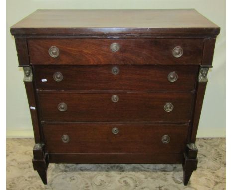 A 19th century mahogany veneered chest in the Empire style fitted with four brass ring pull oak lined drawers flanked by pseu