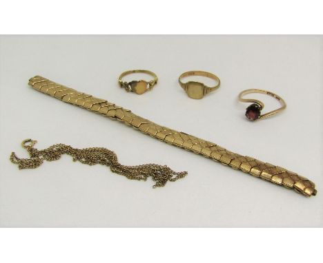 Group of 9ct jewellery comprising a concertina watch strap, garnet crossover ring - size P, two further rings and a fine link