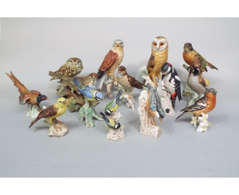 A collection of eleven Goebel matt glazed models of birds including an owl, a pheasant, a nuthatch, a song thrush and a waxwi