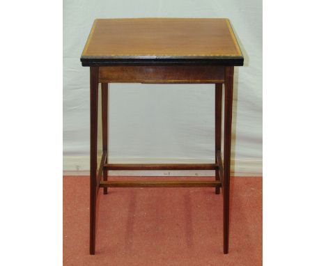 An Edwardian mahogany foldover top card table of simple form, raised on four slender square tapered legs, with satinwood and 