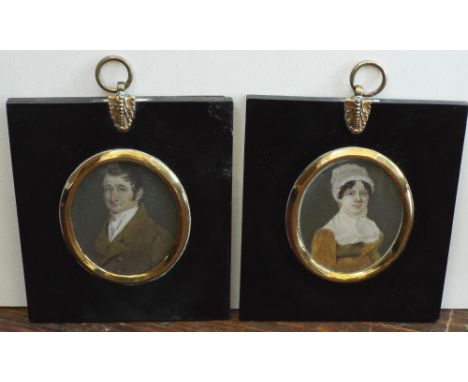 A collection of four miniature portraits comprising a matched pair, probably husband and wife both in early 19th century styl