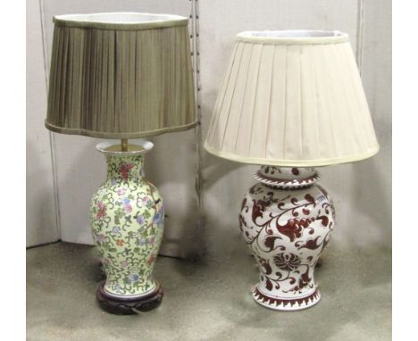 An Italian white glazed and hand painted ceramic table lamp in the form of a baluster shaped vase and cover, together with on