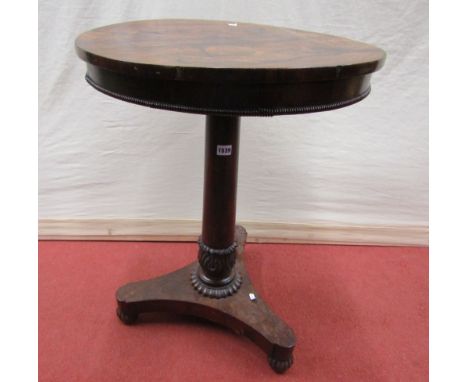 A William IV rosewood occasional table of circular form raised on a central turned pillar, shaped tricorn platform and moulde